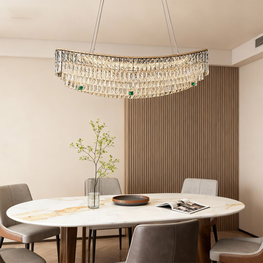 Dining space featuring elegant crystal pendant chandelier with green accents.