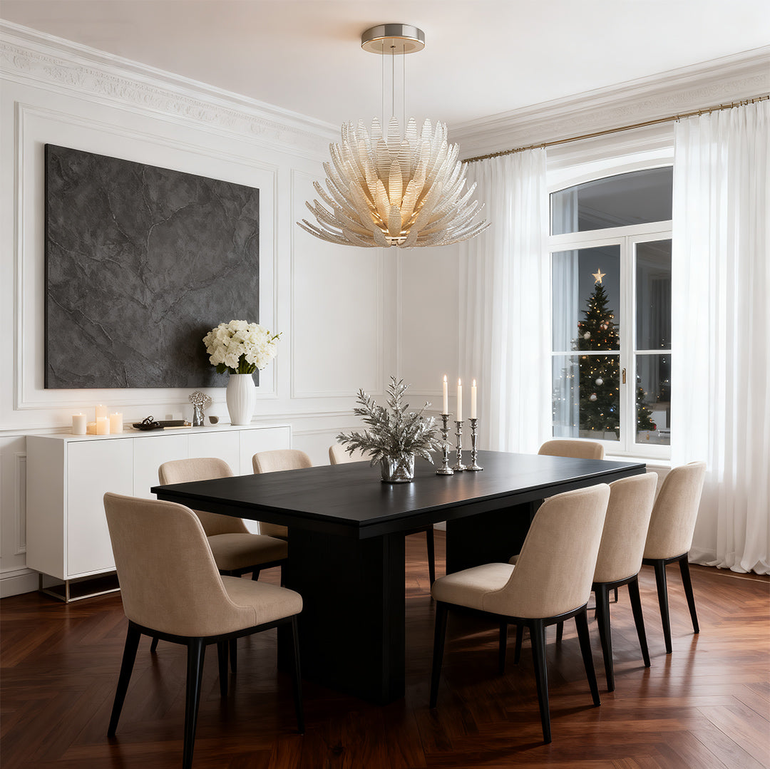 Deco chandelier lighting fixture installed above dining table.