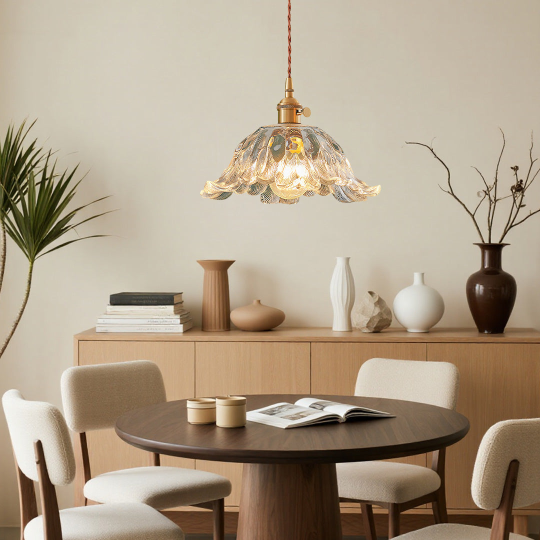 Modern dining room featuring flower pendant lighting over wooden table with natural decor elements.