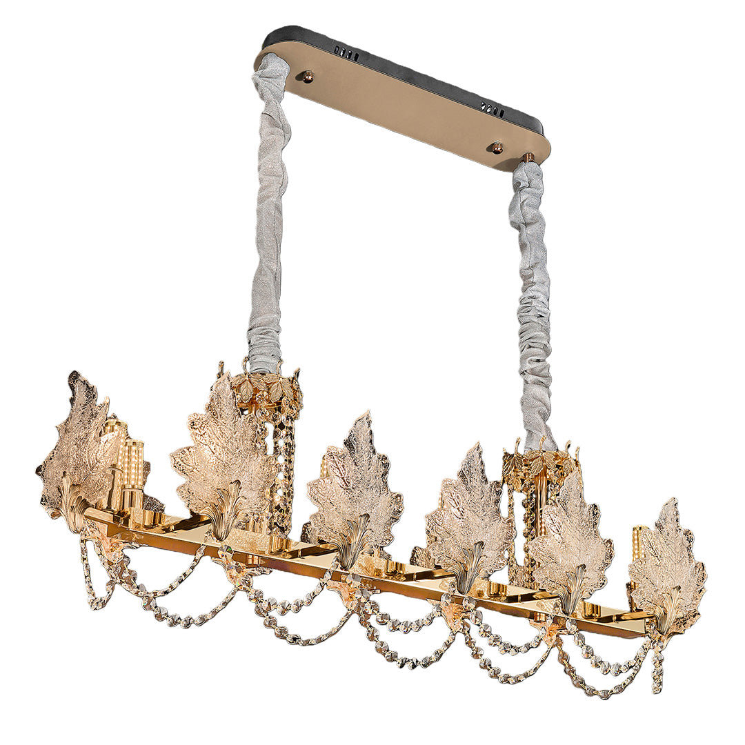 French chandelier lighting a modern dining room with warm glow.