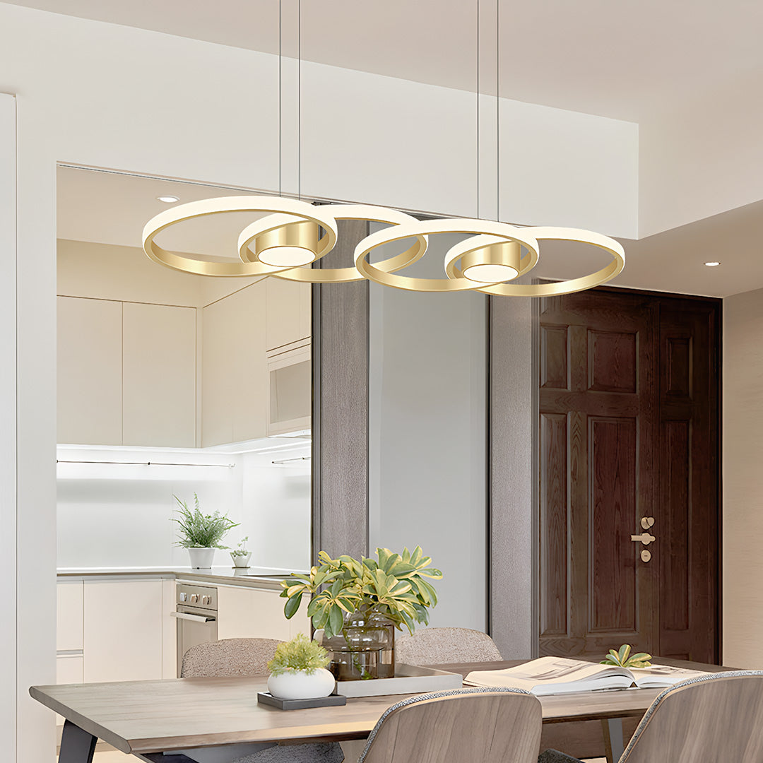 Luxury gold chandelier lamp installed above a dining table, modern interior lighting design