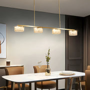 LED linear pendant light illuminating contemporary dining room with neutral decor and wooden table