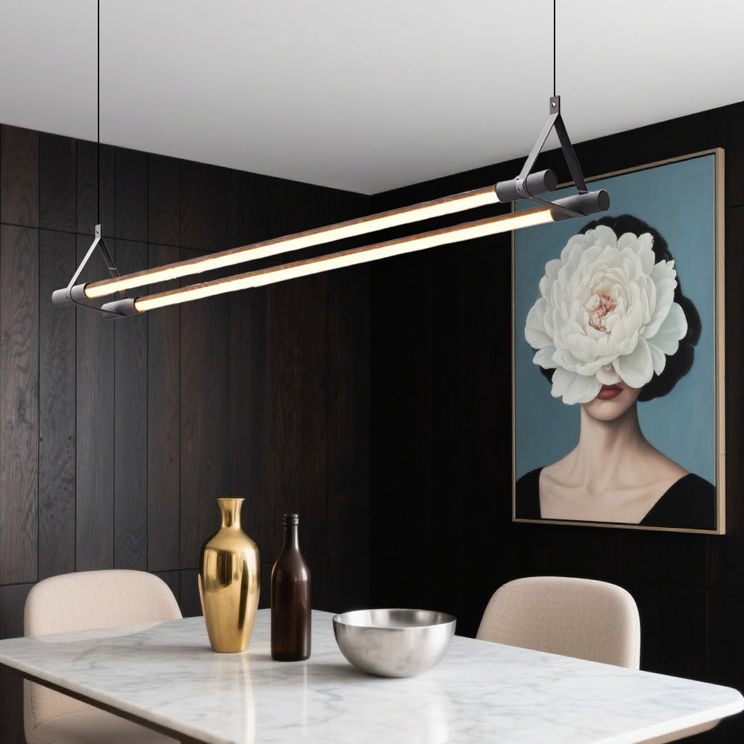 Elegant linear pendant lights installed above dining table showcasing warm LED strip illumination