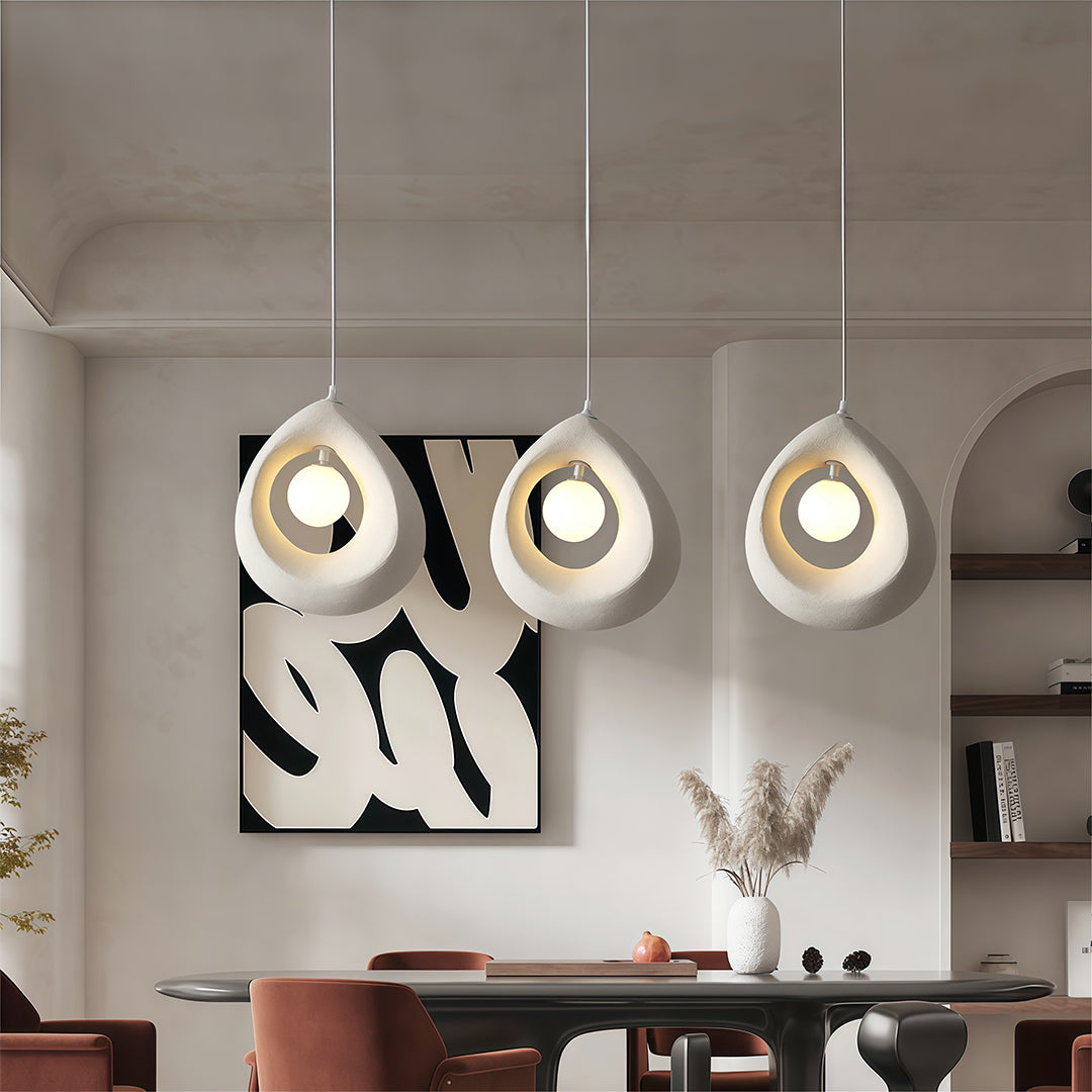 Set of Statement Pendant Lights with teardrop forms hanging elegantly above a dining table.