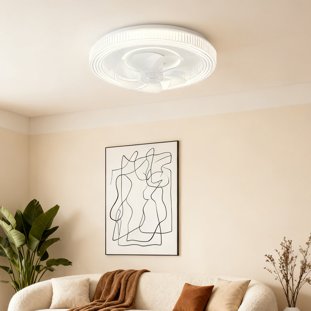 Discreet circular ceiling fan with light illuminating a minimalist living space with a large abstract poster and brown sofa. 