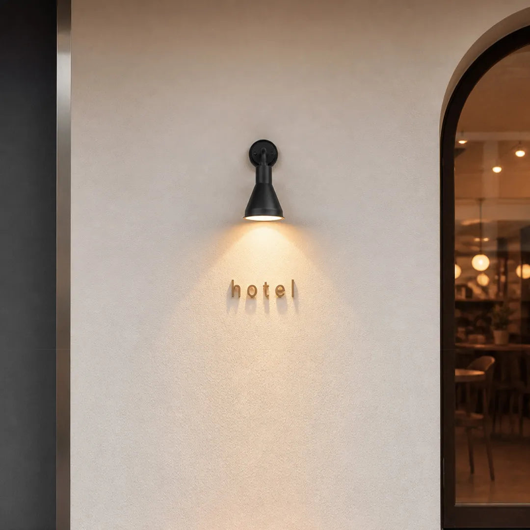 Wall sconces outdoor lighting mounted beside a doorway creating warm downward illumination.
