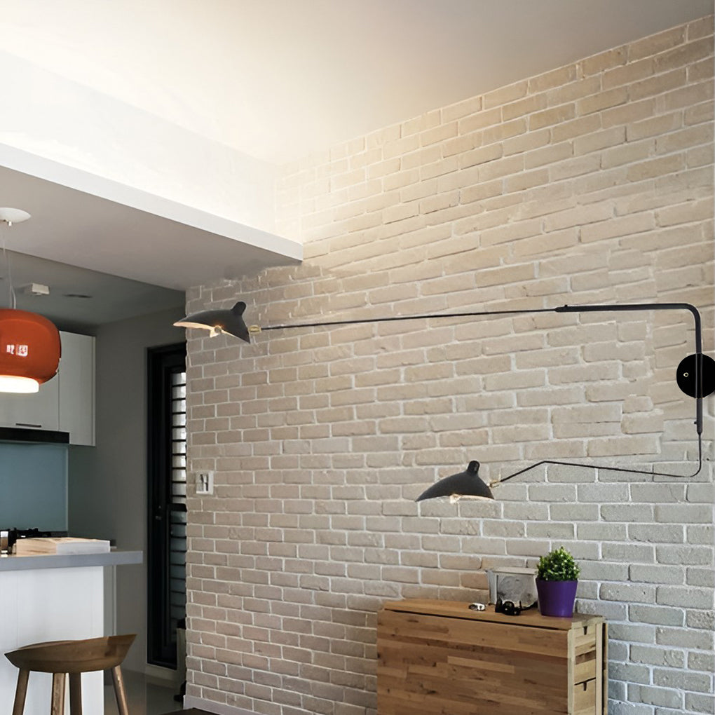 Double arm wall sconce installed on a brick wall, blending industrial style with practical swing arm lighting.