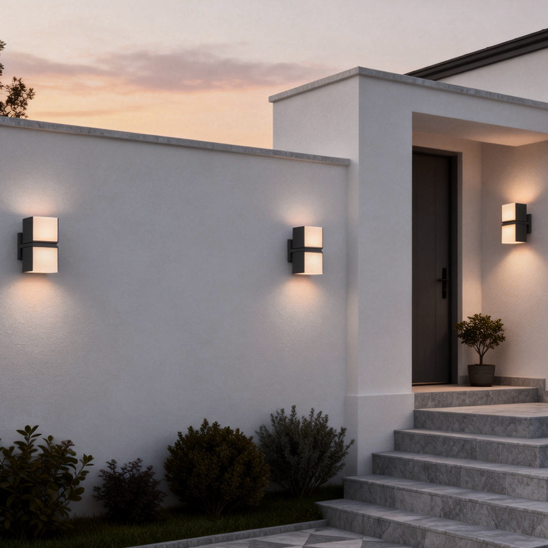 Minimalist double head wall light installed on an exterior wall, casting soft up and down lighting along a modern home facade.
