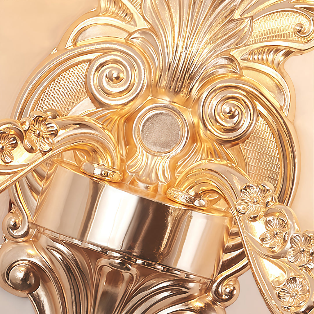 Double lamp wall lights with a close-up of their decorative gold frame and lampshades.