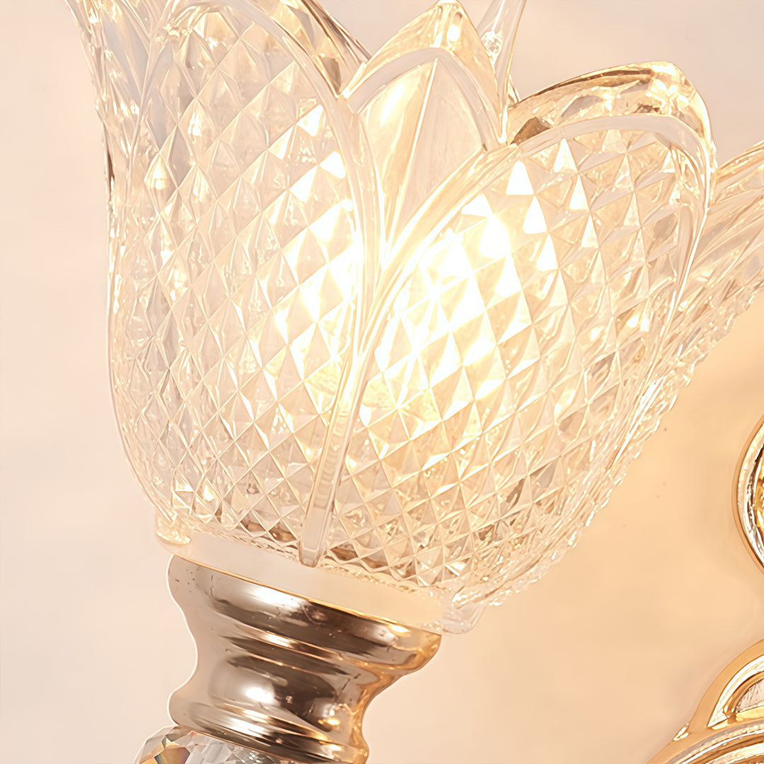 Double lamp wall lights with a close-up of their intricate gold and glass design.