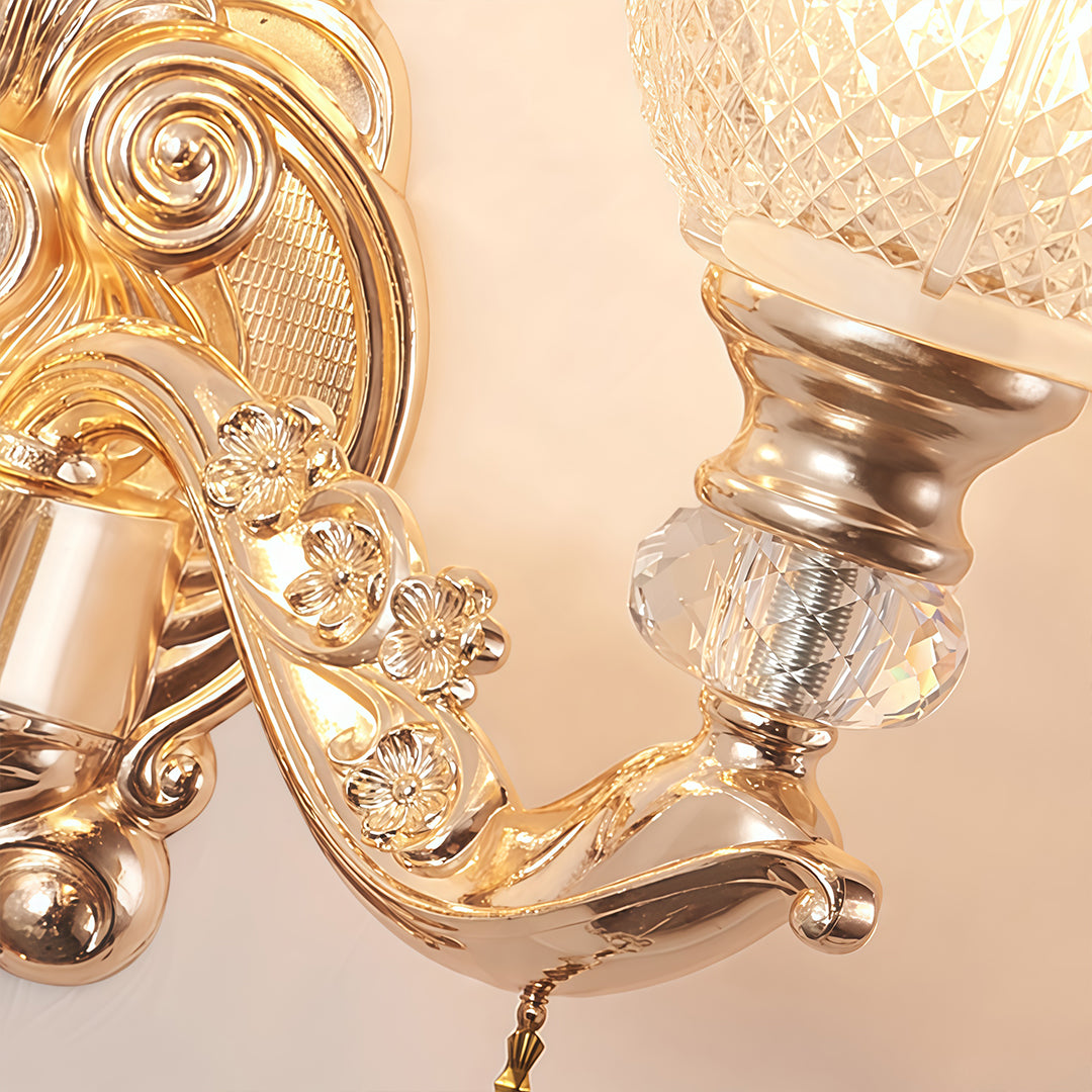 Double lamp wall lights with a crystal and gold finish, enhancing a sophisticated living area.