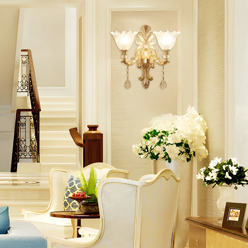 Double lamp wall lights with a gold finish, providing warm light in a luxurious living room.