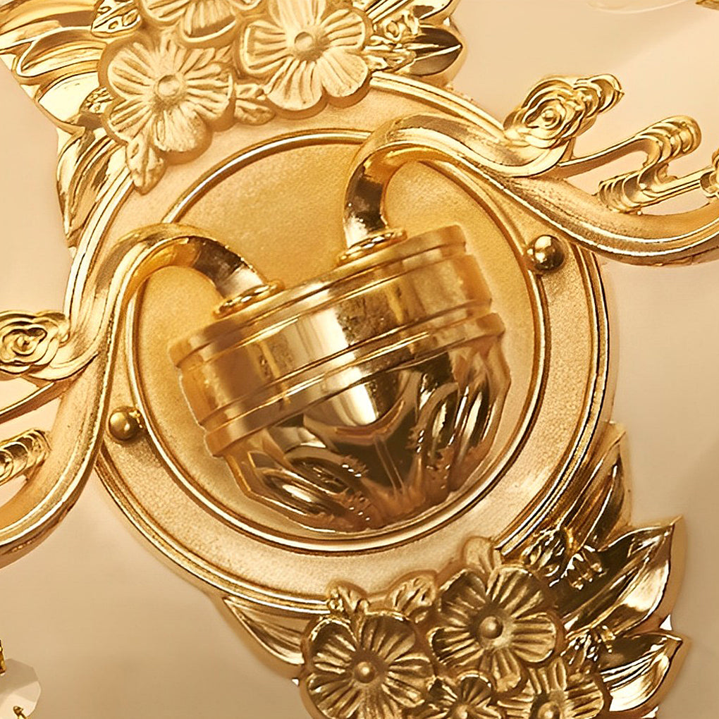 Double lamp wall lights with a vintage design, illuminating a classic interior with floral arrangements.