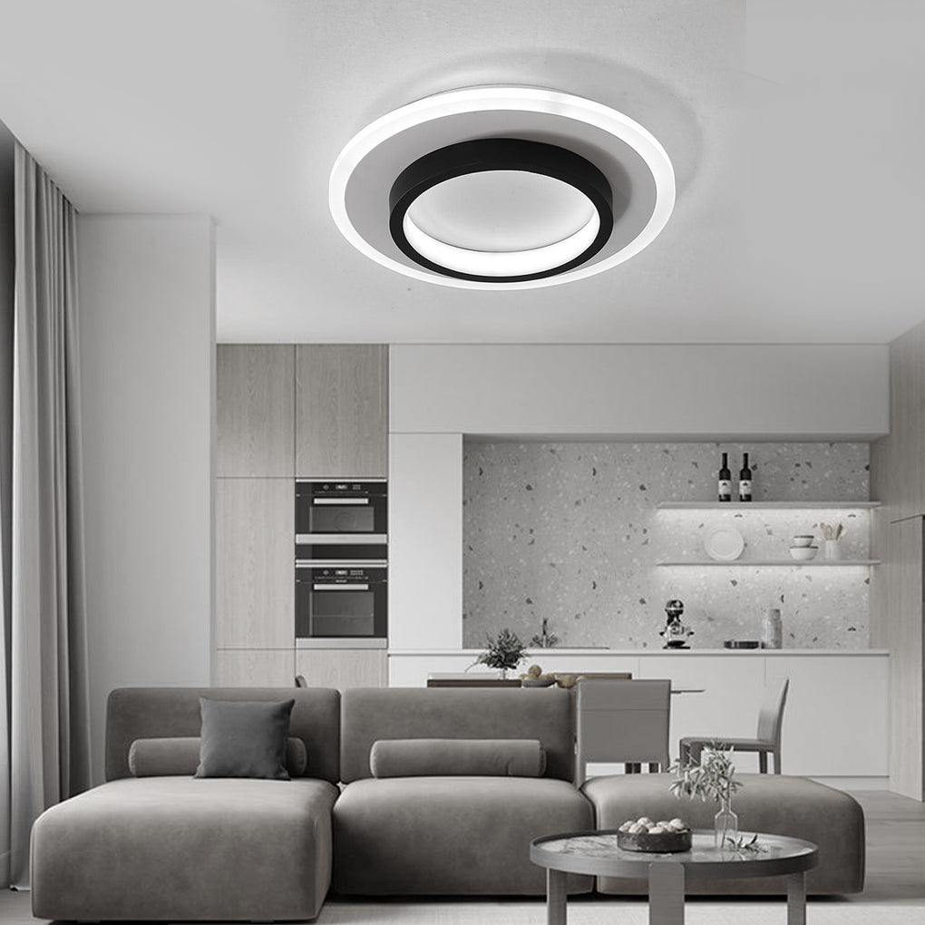 Double ring flush mount casting a gentle glow in a chic open-plan living area.