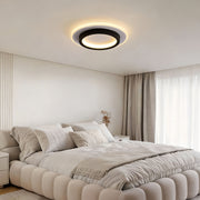 Double ring flush mount illuminating a modern bedroom with warm, ambient glow.