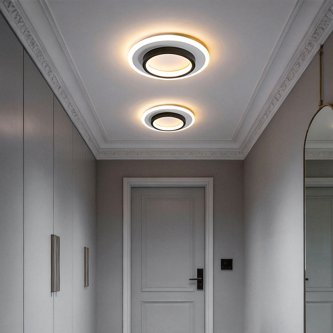 Double ring flush mount providing soft light in a contemporary hallway.