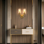 Double sconce wall light creating warm ambiance in contemporary entryway with console table