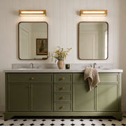 Double sink bathroom setup with wood vanity mirror light fixtures.