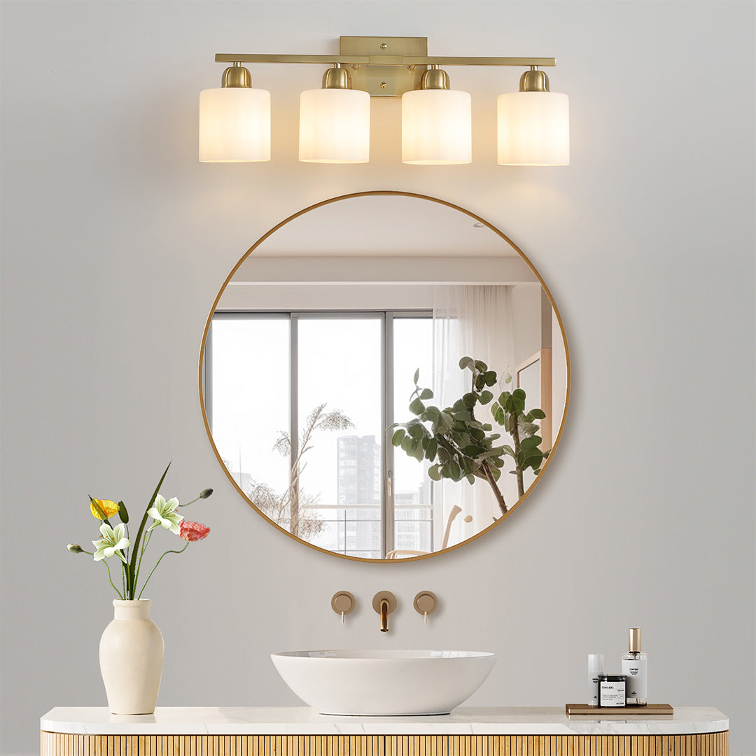 Modern bathroom vanity light with three bulbs, mounted above a double sink with round mirrors.
