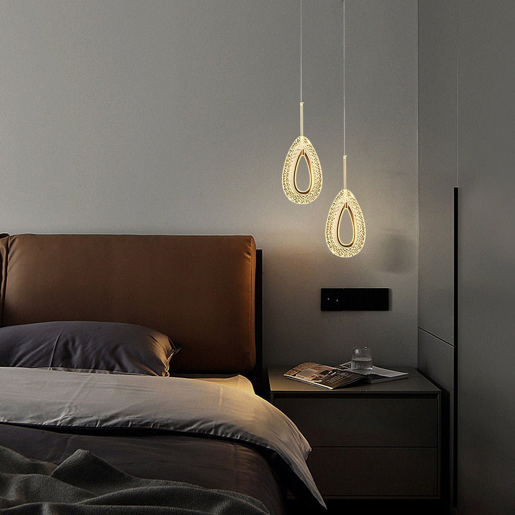 Two unique pendant lights hanging above a modern bedroom nightstand.