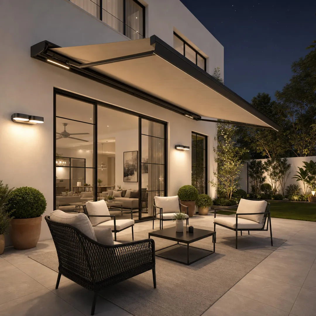 Double wall lights illuminating a contemporary outdoor patio with lounge seating at night.