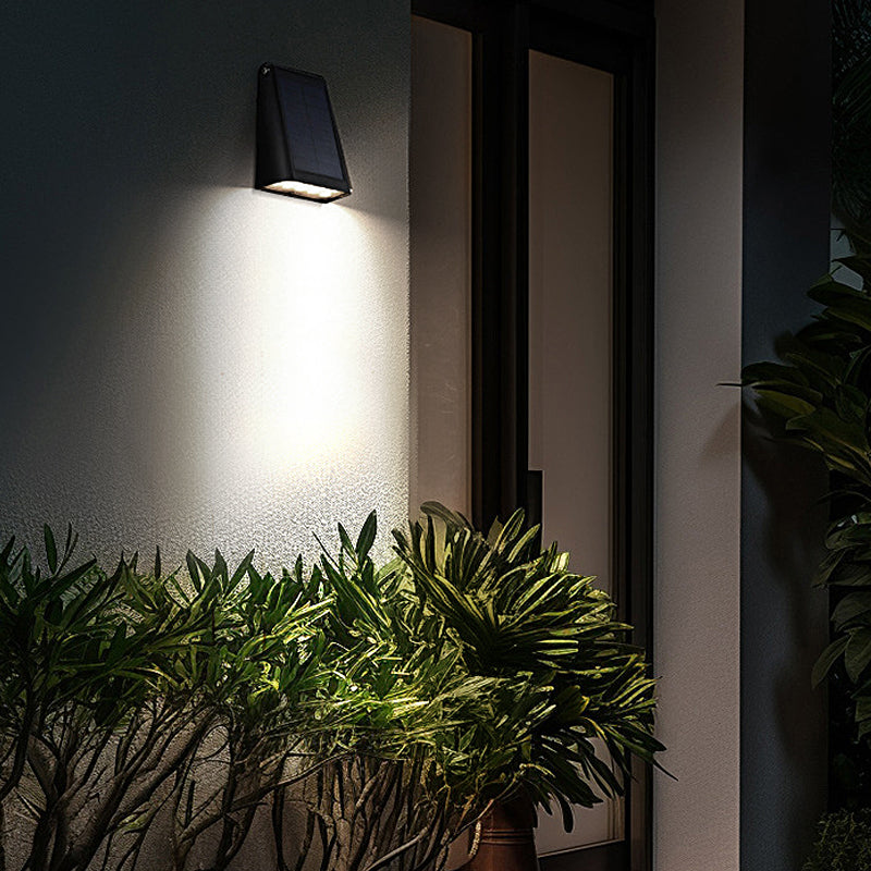 Down light wall sconce lighting a modern exterior wall at night