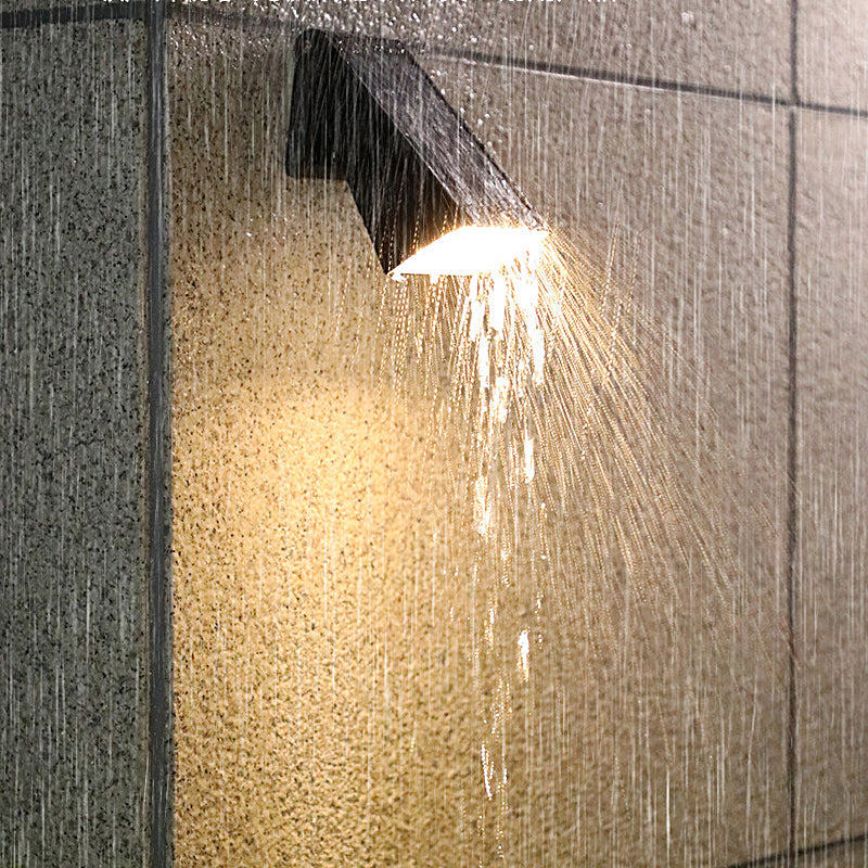 Down light wall sconce operating under rain to demonstrate waterproof design