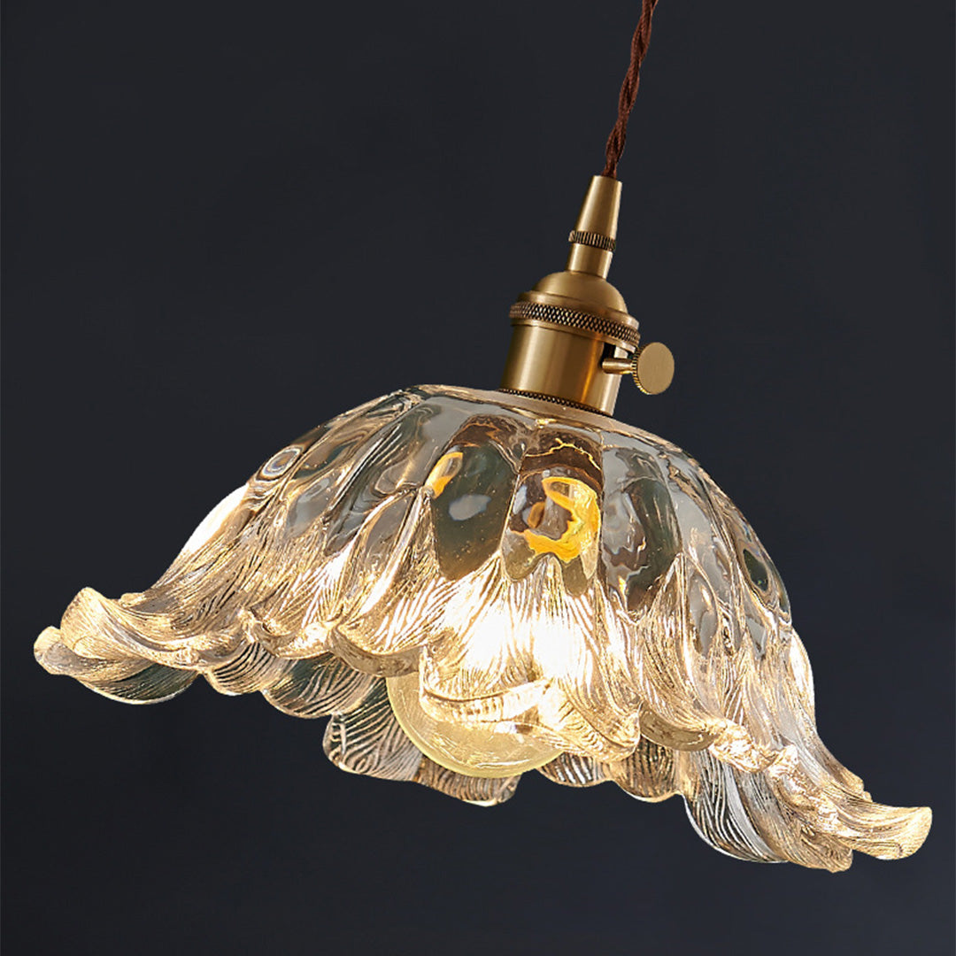 Dramatic flower pendant lighting with golden brass finish creating ambient lighting against dark background.