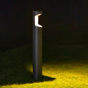 Illuminated bollard creating dramatic ground wash lighting effect at night