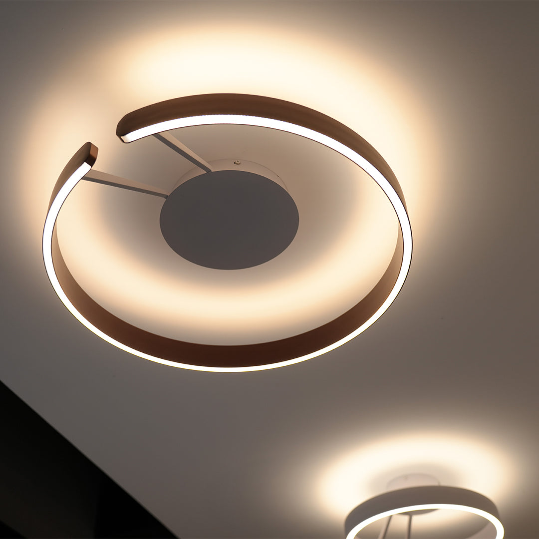 Dramatic halo flush mount ceiling light with glass shade chandelier influence in black with golden LED ring creating ambient glow.