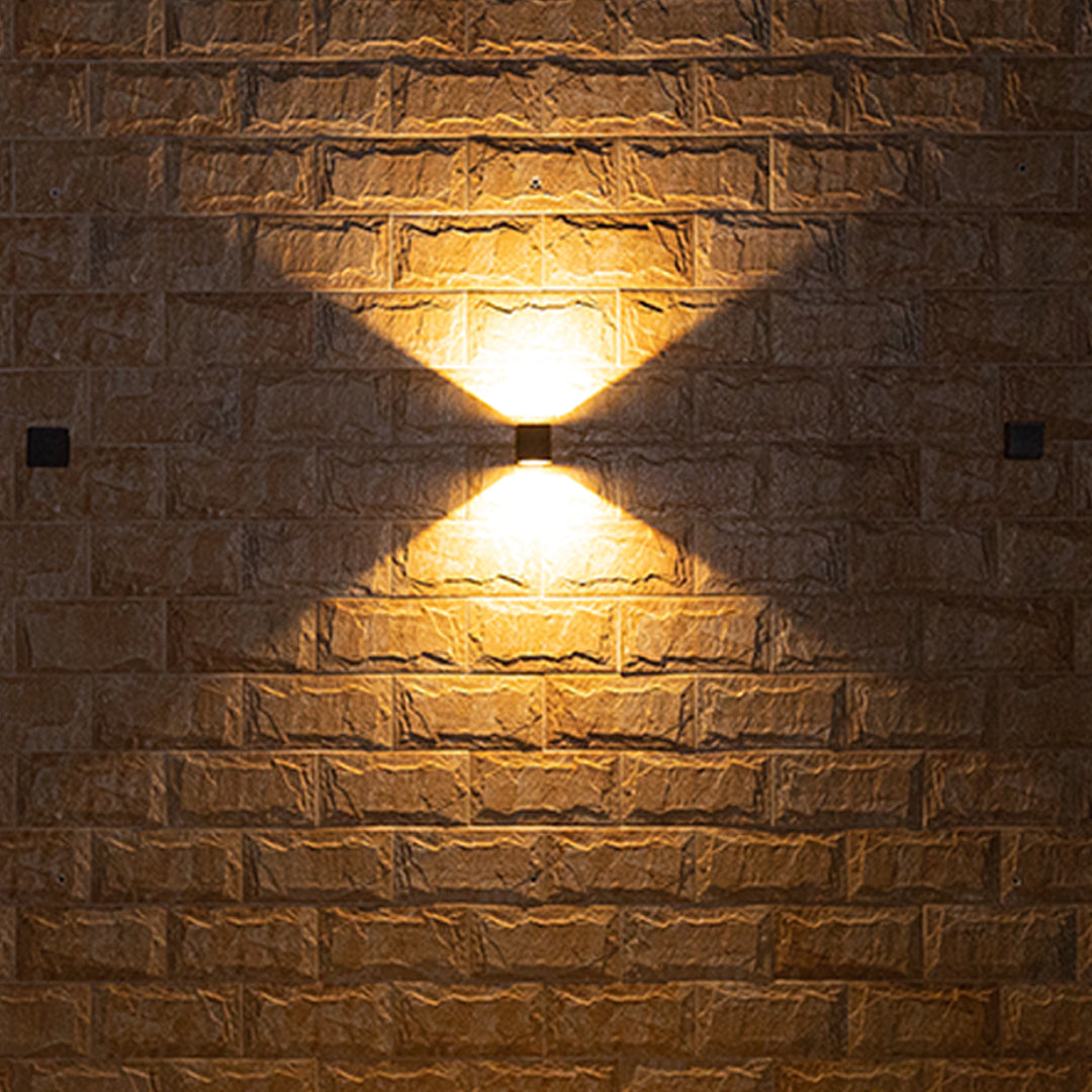 Close-up of a rustic brick wall showing the dramatic intersecting light beams from the Outdoor Wall Light Waterproof fixture.