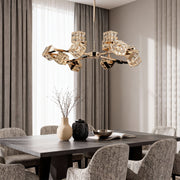 Dramatic luxury chandeliers crystal featuring glass shade chandelier styling illuminating modern dining room with dark wood table.