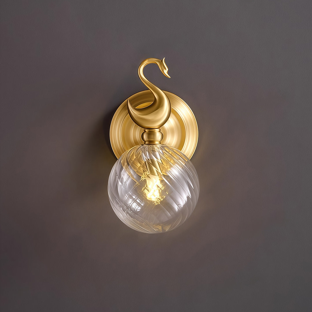 Dramatic wall mounted LED light with glass shade chandelier aesthetic shown illuminated on dark background highlighting details.