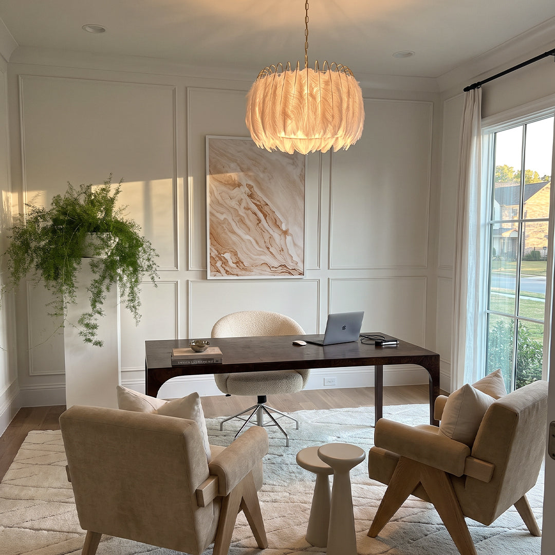 Drum light chandelier hanging above a desk in a bright home office with paneled walls.
