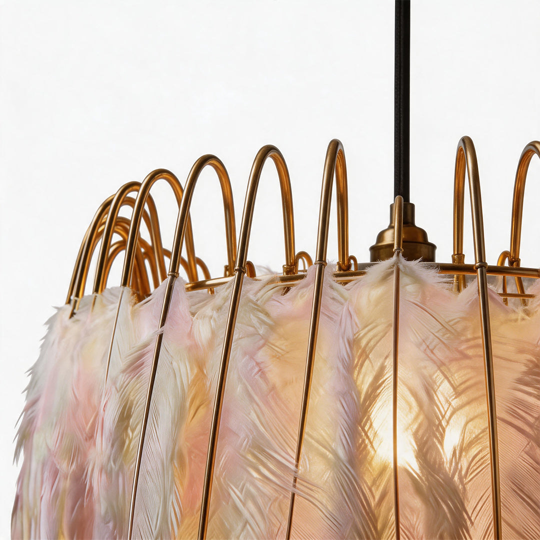 Close-up of pink feather details and gold frame on a drum light chandelier.