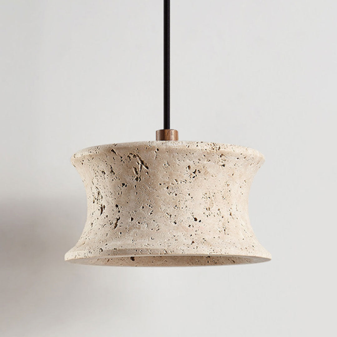 Close-up of drum pendant light fixture showing the textured stone shade and curved silhouette.