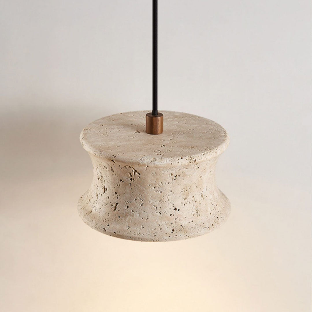 Close-up of drum pendant light fixture showing the top opening, stone texture, and suspension rod.