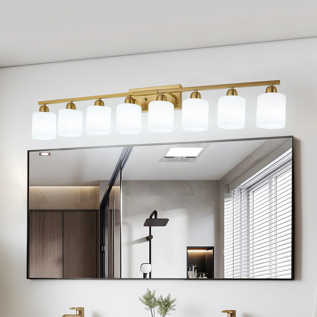 Modern bathroom vanity light with three bulbs and a sleek black finish, mounted above dual mirrors.