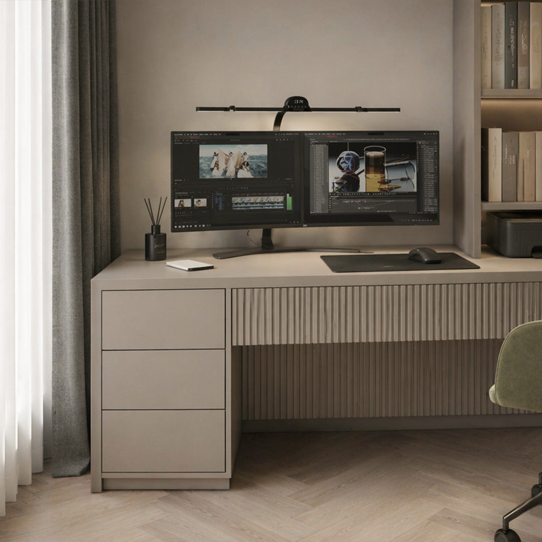 Dual monitor light bar mounted above a computer screen in a minimalist home office with built-in cabinetry.