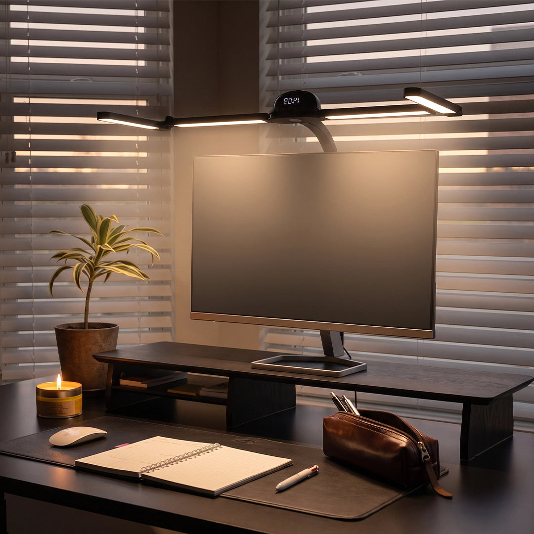 Dual monitor light bar providing focused desk illumination above a widescreen monitor with adjustable side arms.