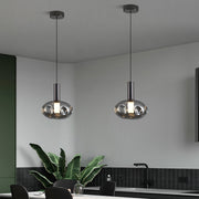 Dual drum pendant lights providing task lighting over kitchen workspace area