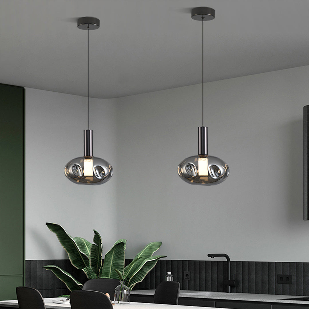 Dual drum pendant lights providing task lighting over kitchen workspace area
