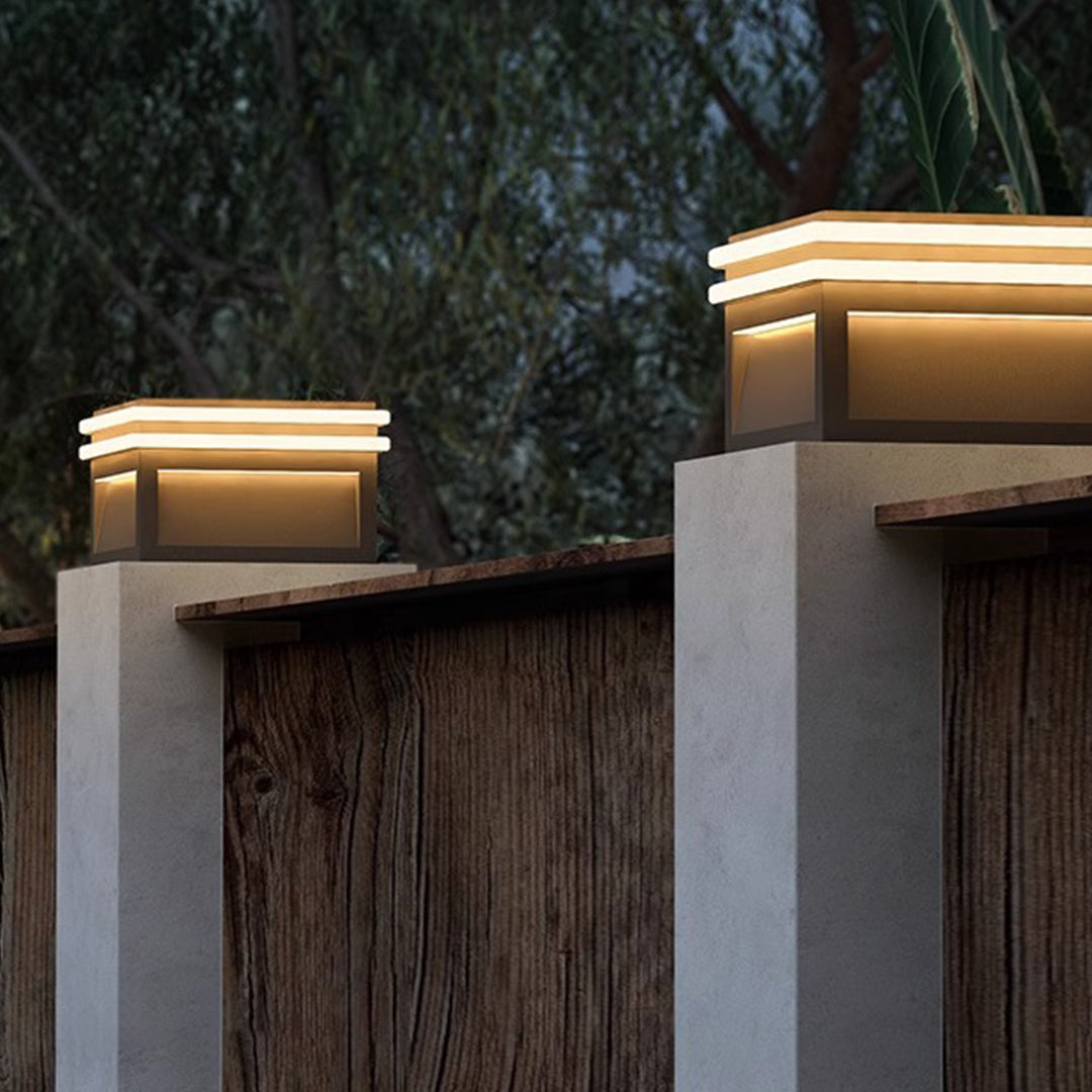 Dual-tone cubic outdoor light fixture with contrasting materials and warm LED accent lighting effect