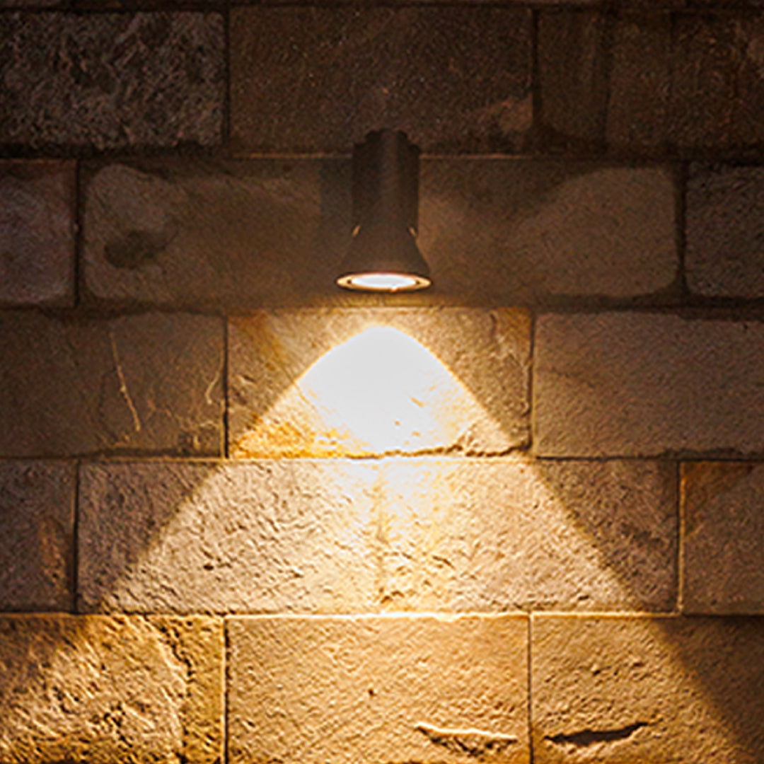 Focused warm illumination from a durable single-beam Outdoor Wall Lighting Fixture mounted on a classic brick exterior.