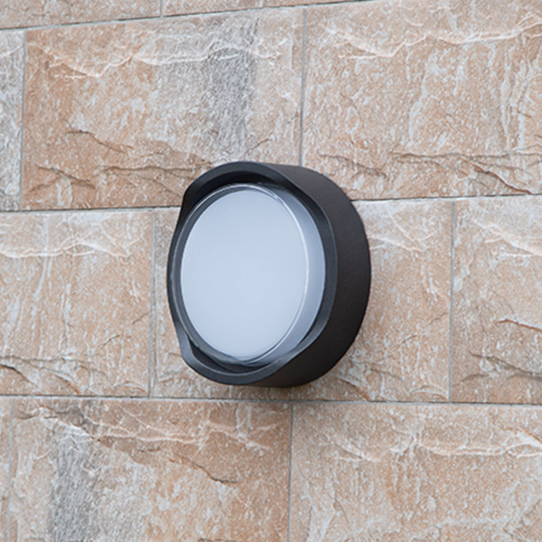 Modern black circular wall light with white LED panel for contemporary interior applications