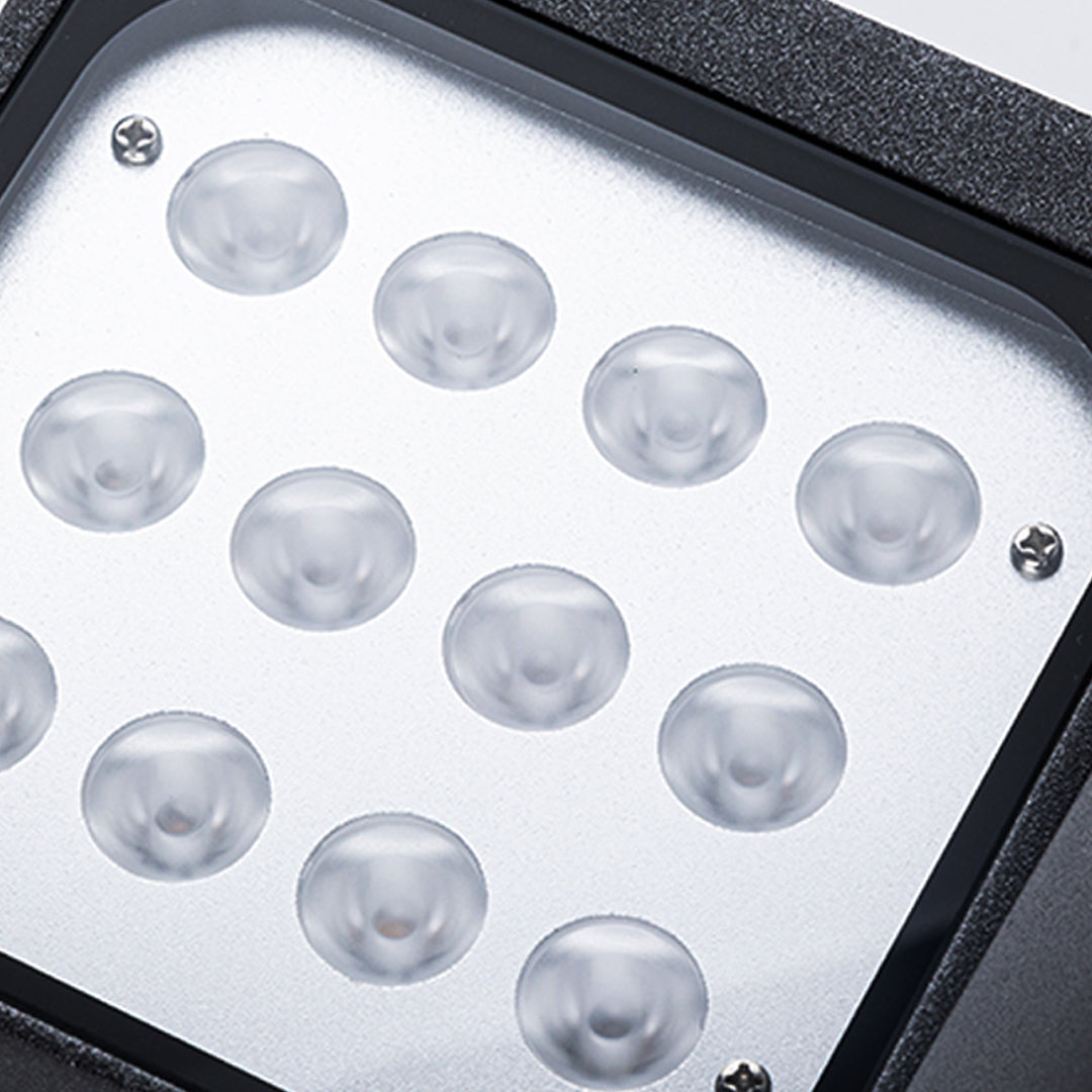 Close-up view of bronze outdoor light fixture showing curved arm and mounting details