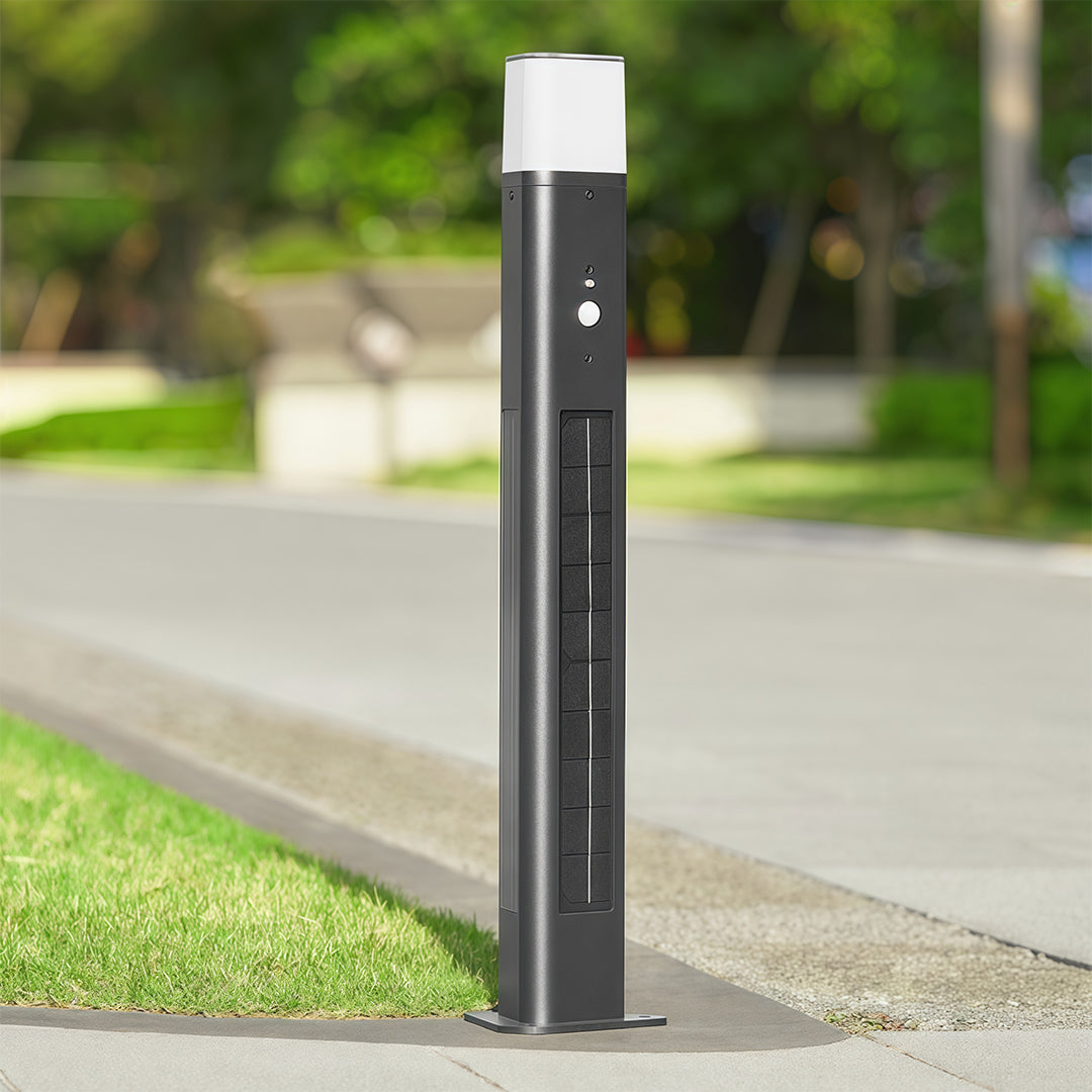 Black solar bollard lighting illuminating a garden path, creating a welcoming and eco-friendly ambiance.