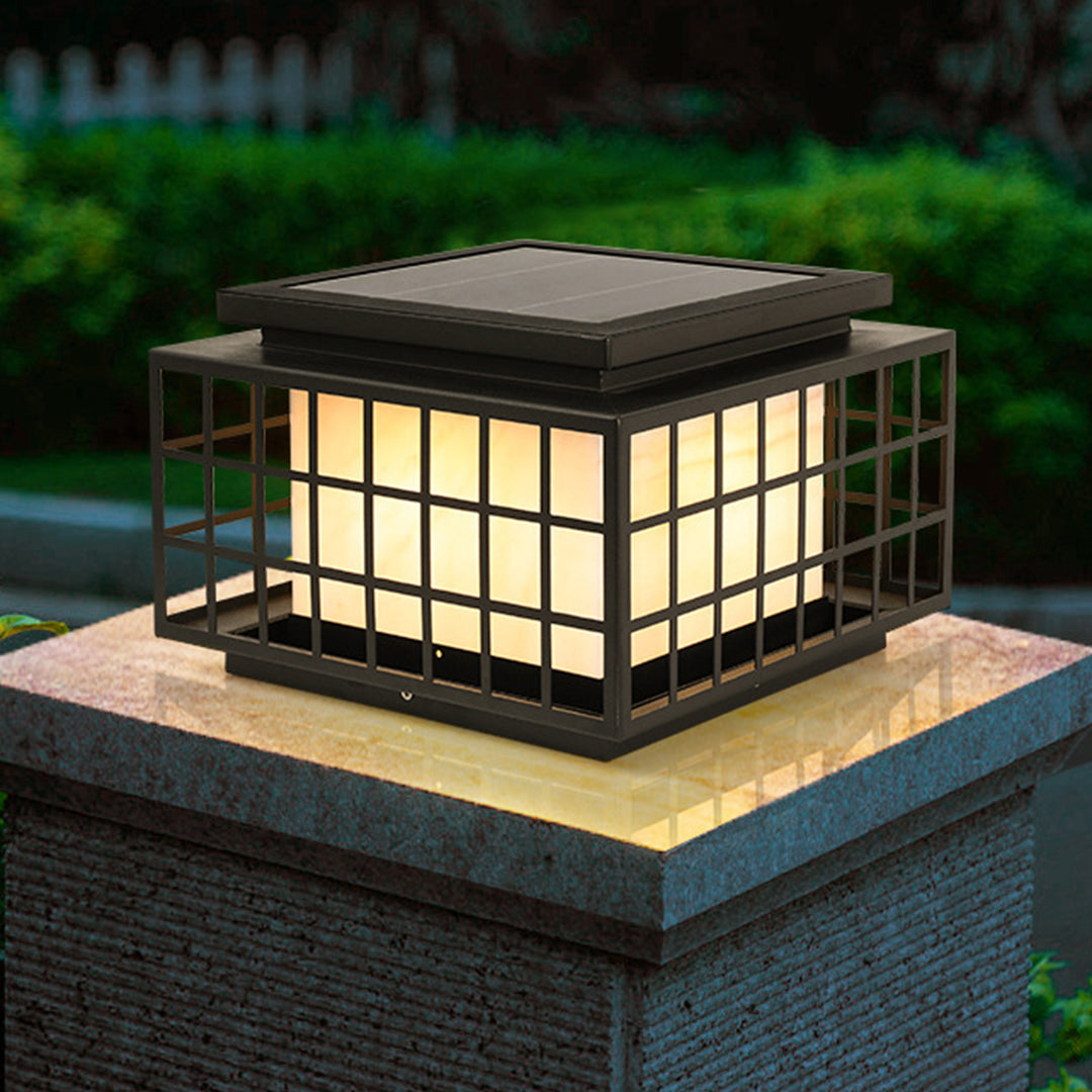 Japanese-style solar lanterns placed on stone surface creating peaceful zen garden atmosphere with natural rock elements