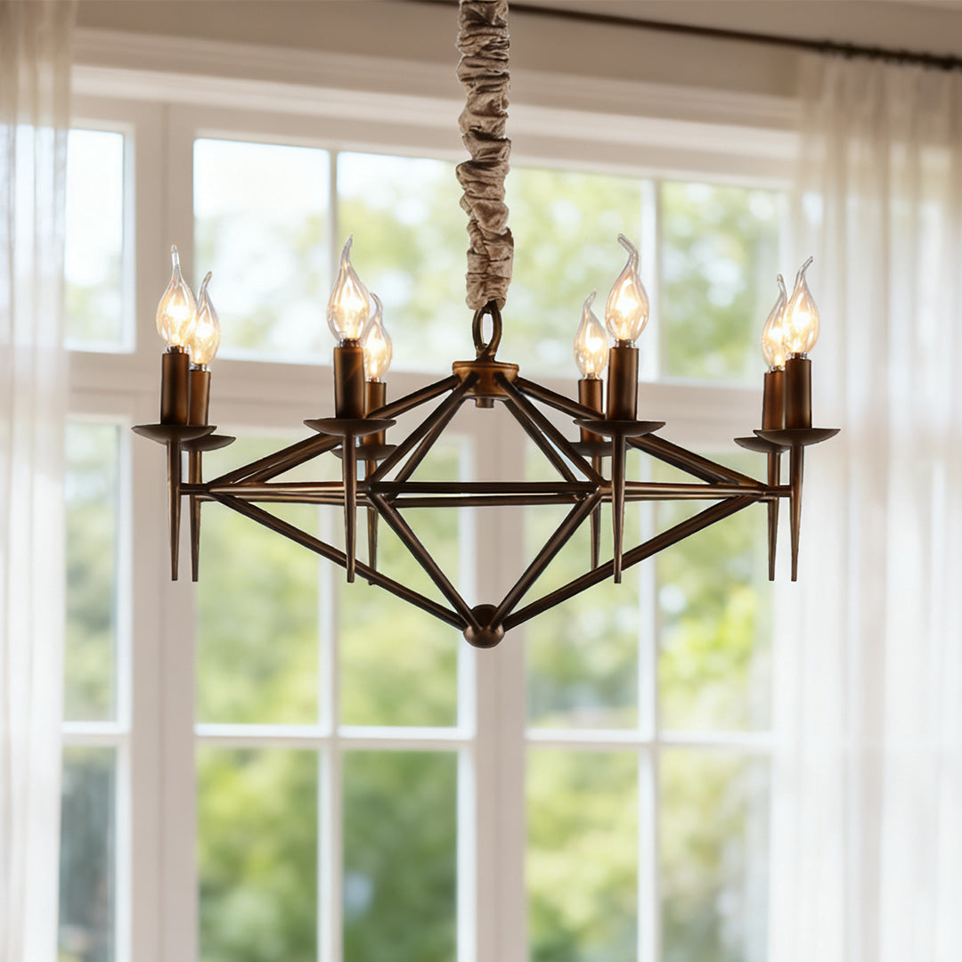 Close-up of the eight-light brown chandelier fixture, highlighting the wrought iron finish and decorative chain in a bright window setting.