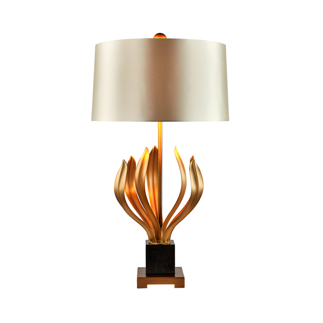 Elegant gold metal table lamp with artistic sculptural base and beige lampshade